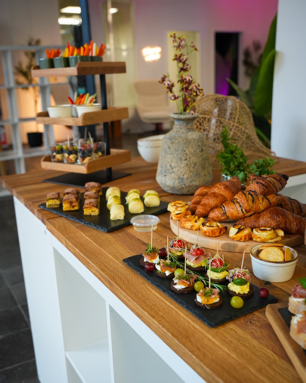 Buffet mit Croissants, Fingerfood und Gemüsesticks auf der Theke der Etage